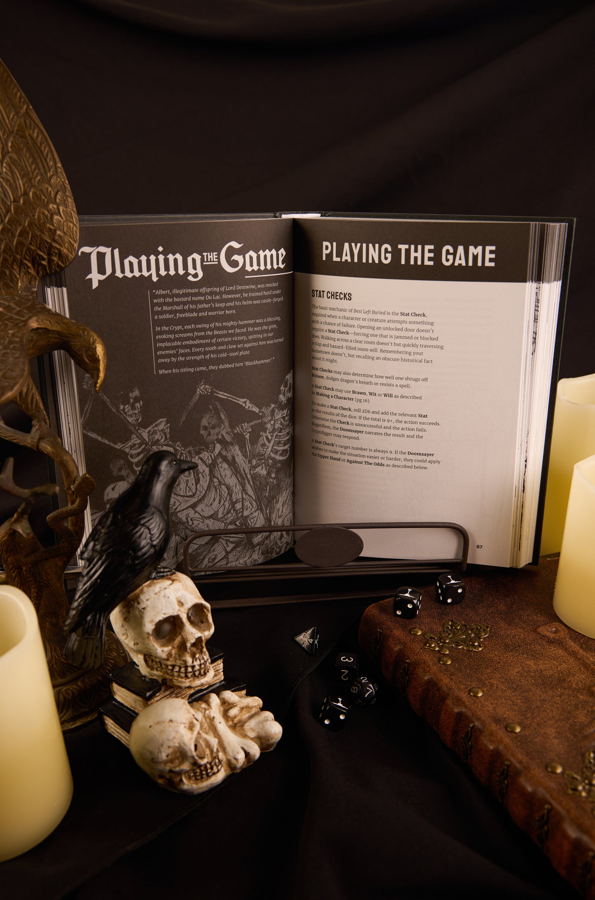 Open double page spread of Best Left Buried Deeper titled 'Playing the Game' with candles and decorative items on a dark surface