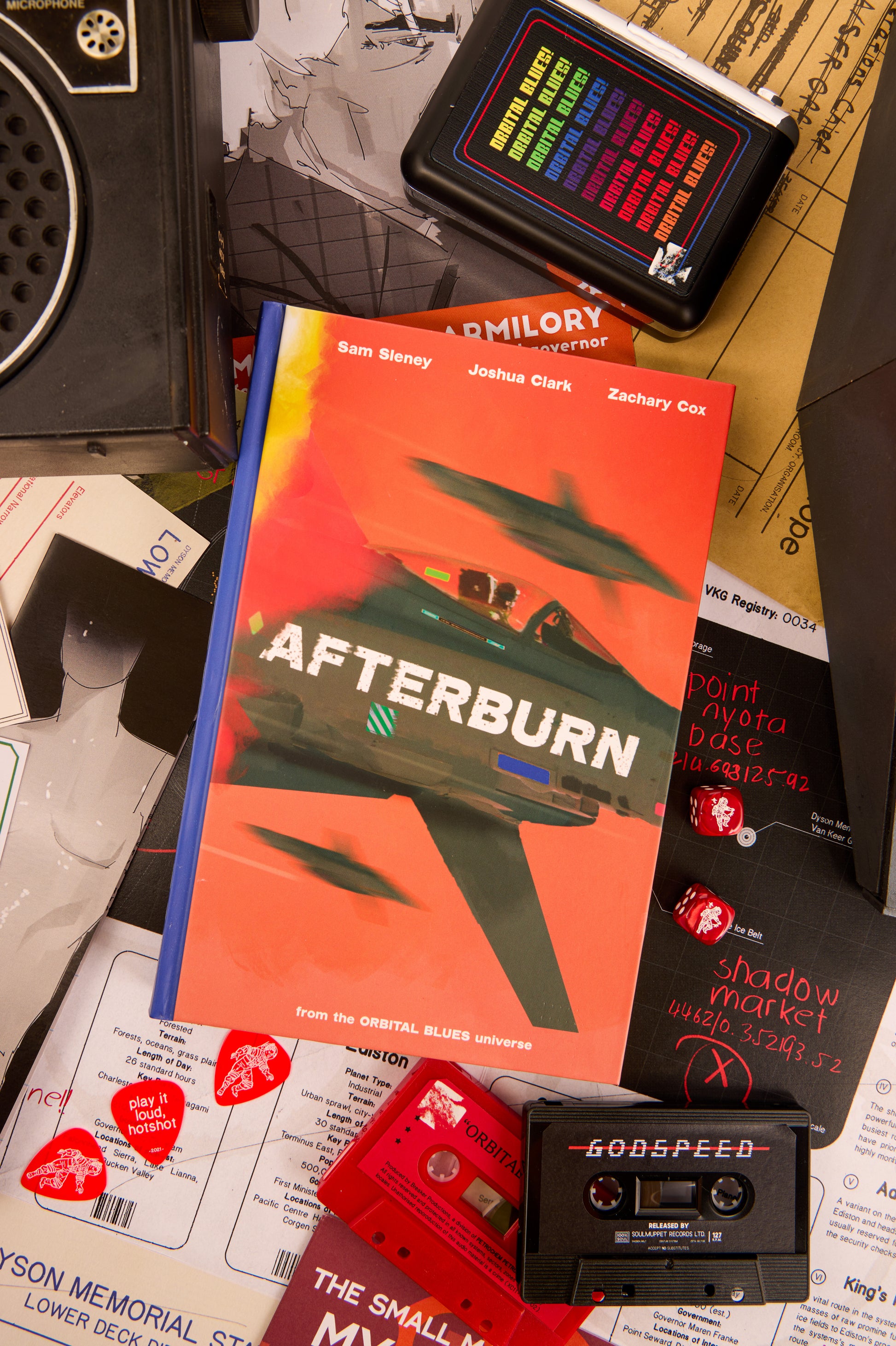 Book titled 'Afterburn' with a cassette tape and other items on a surface